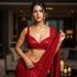 Woman in a red sequined saree standing in an indoor setting with blurred background