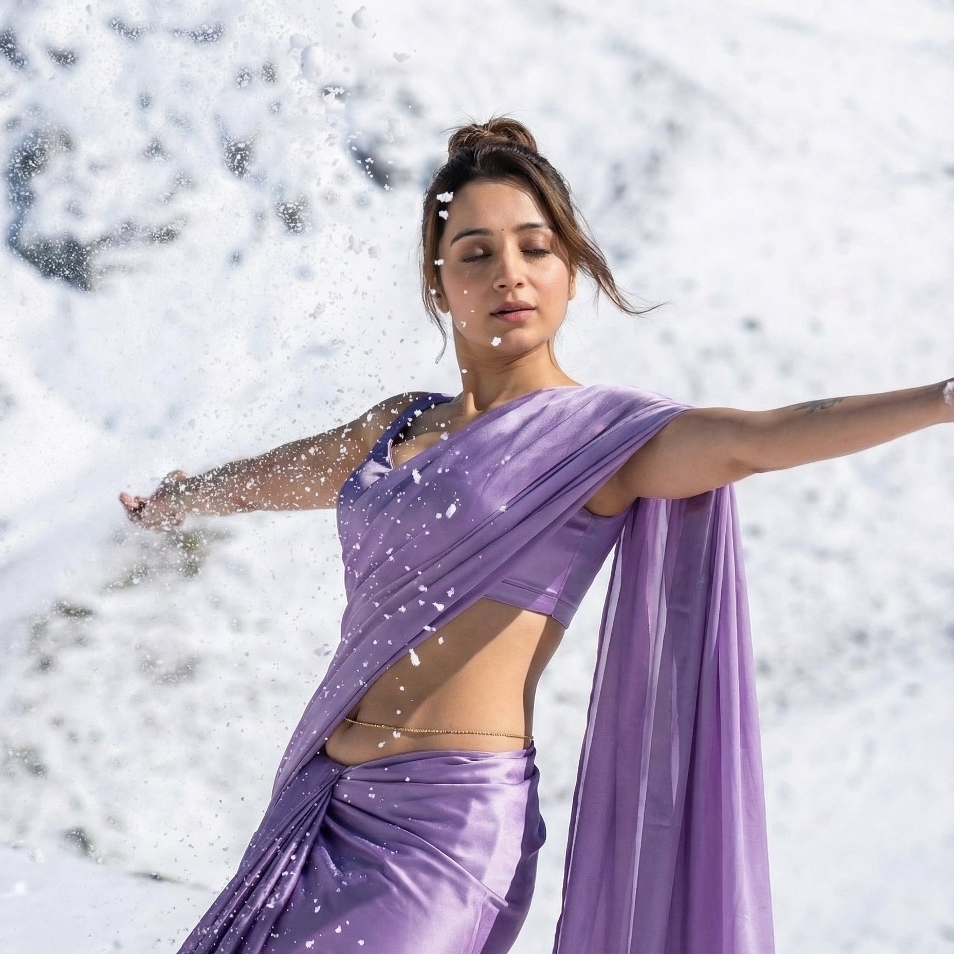 Woman in a purple saree standing in a snowy landscape