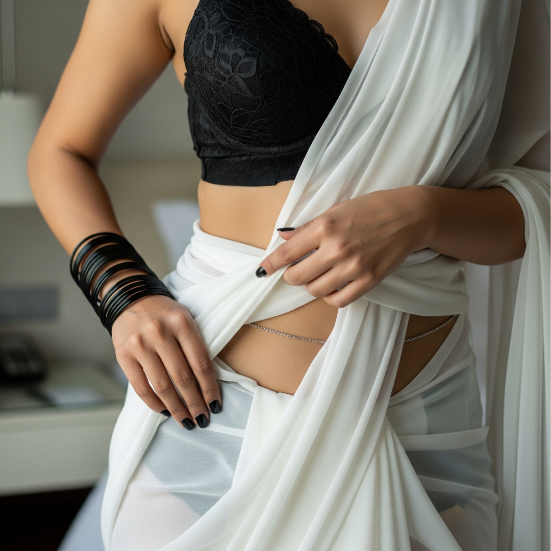 Person wearing a black top and white flowing garment indoors