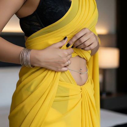 Person wearing a yellow saree with a blurred background