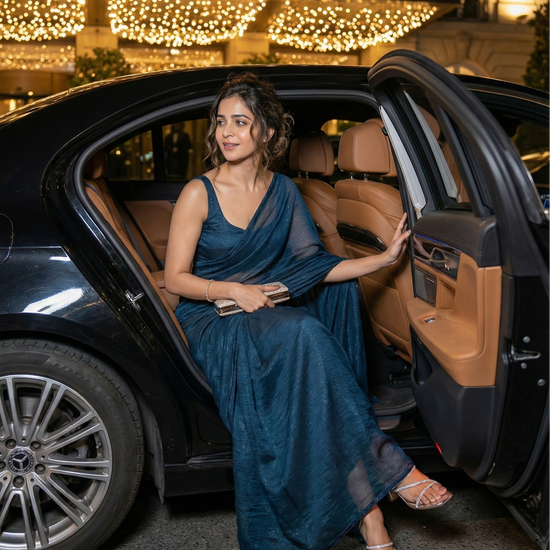 Woman in Moonlit Teal saree – teal shimmer georgette for evenings where subtle allure does the talking