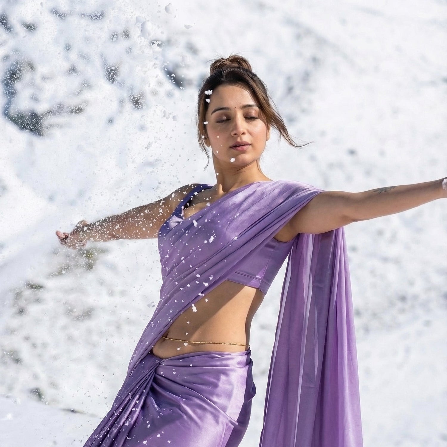Woman in a purple saree standing in a snowy landscape