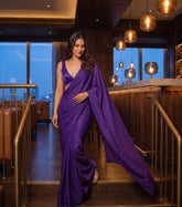 Woman descending bar steps in the Orchid Noir purple chiffon saree