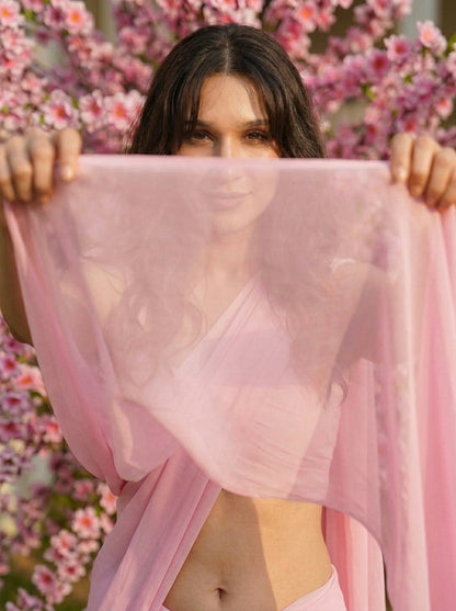 Woman framing her face with the pallu of the Cherry Bloom Chiffon Saree – baby pink chiffon close-up