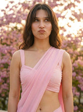 Woman in Cherry Bloom Chiffon Saree – baby pink chiffon saree, side profile