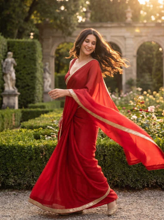 Woman turning in the Scarlet Affair After Dark Saree, red pallu in motion
