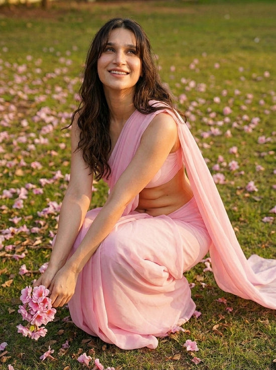 Woman in Cherry Bloom Chiffon Saree holding flowers – baby pink chiffon spring lifestyle shot