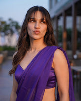 Close-up of a woman posing in the Orchid Noir purple chiffon saree